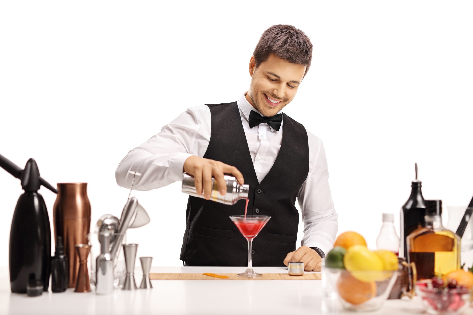 Barman pouring his signature cocktail in a glass